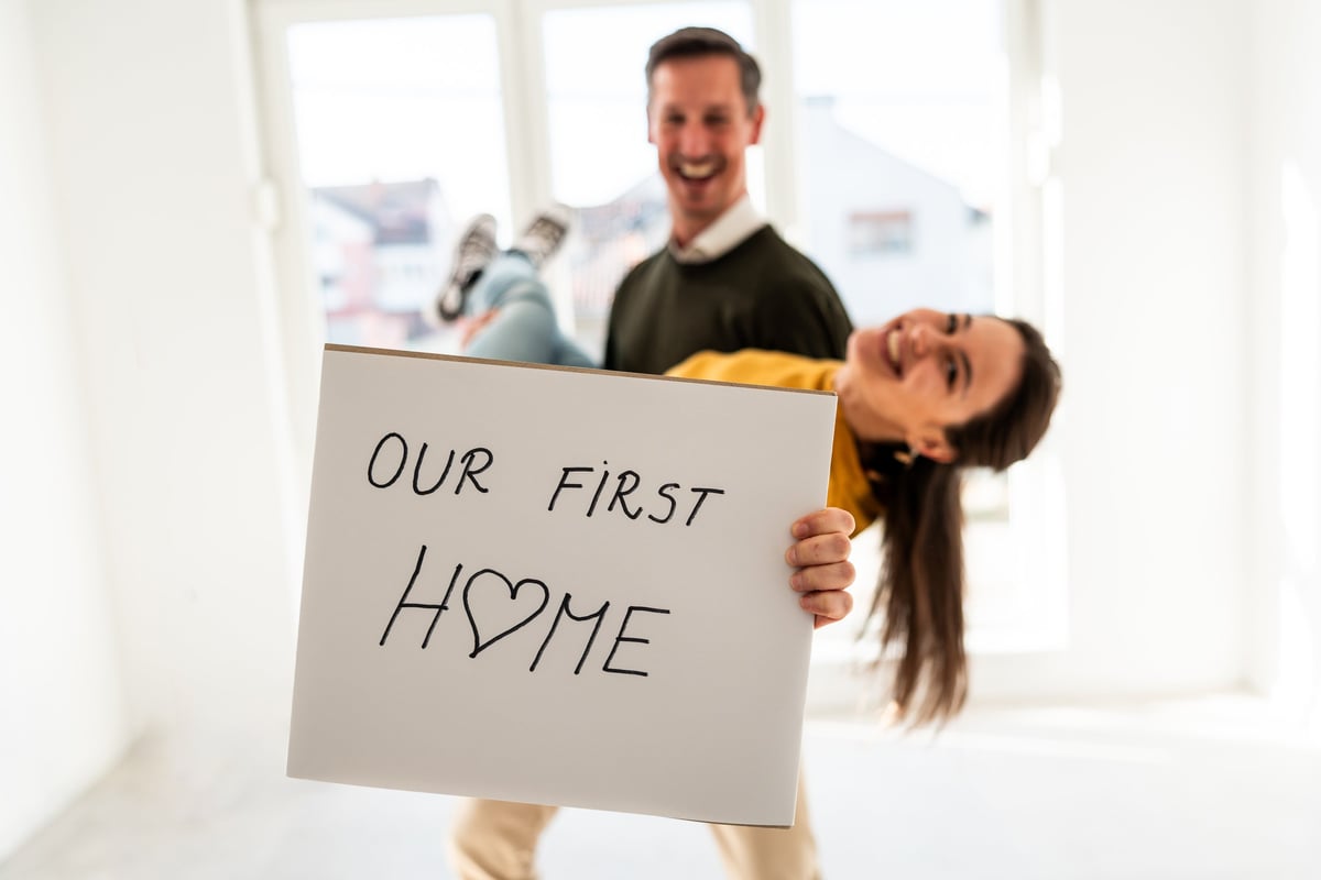 Couple celebrating new home purchase with mortgage advisor