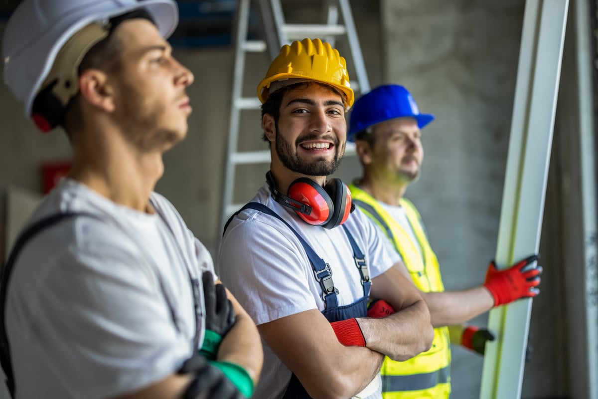 Professional construction team in safety gear standing confidently together